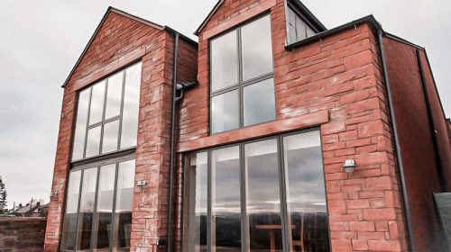 Rear view of two story sandstone house